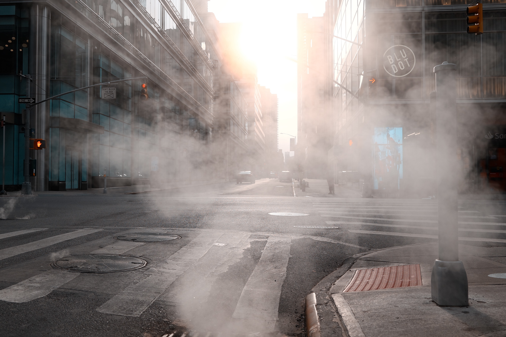 Urban intersection with steam and side light photographed on the street